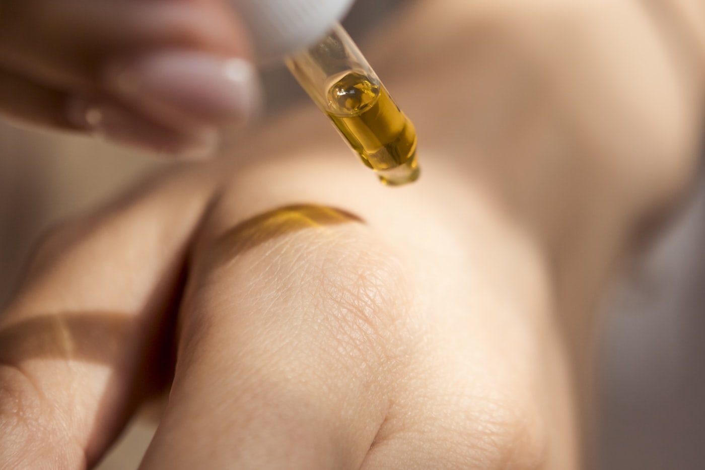 Dropper of golden cannabis oil, a calming option for evening and sleep