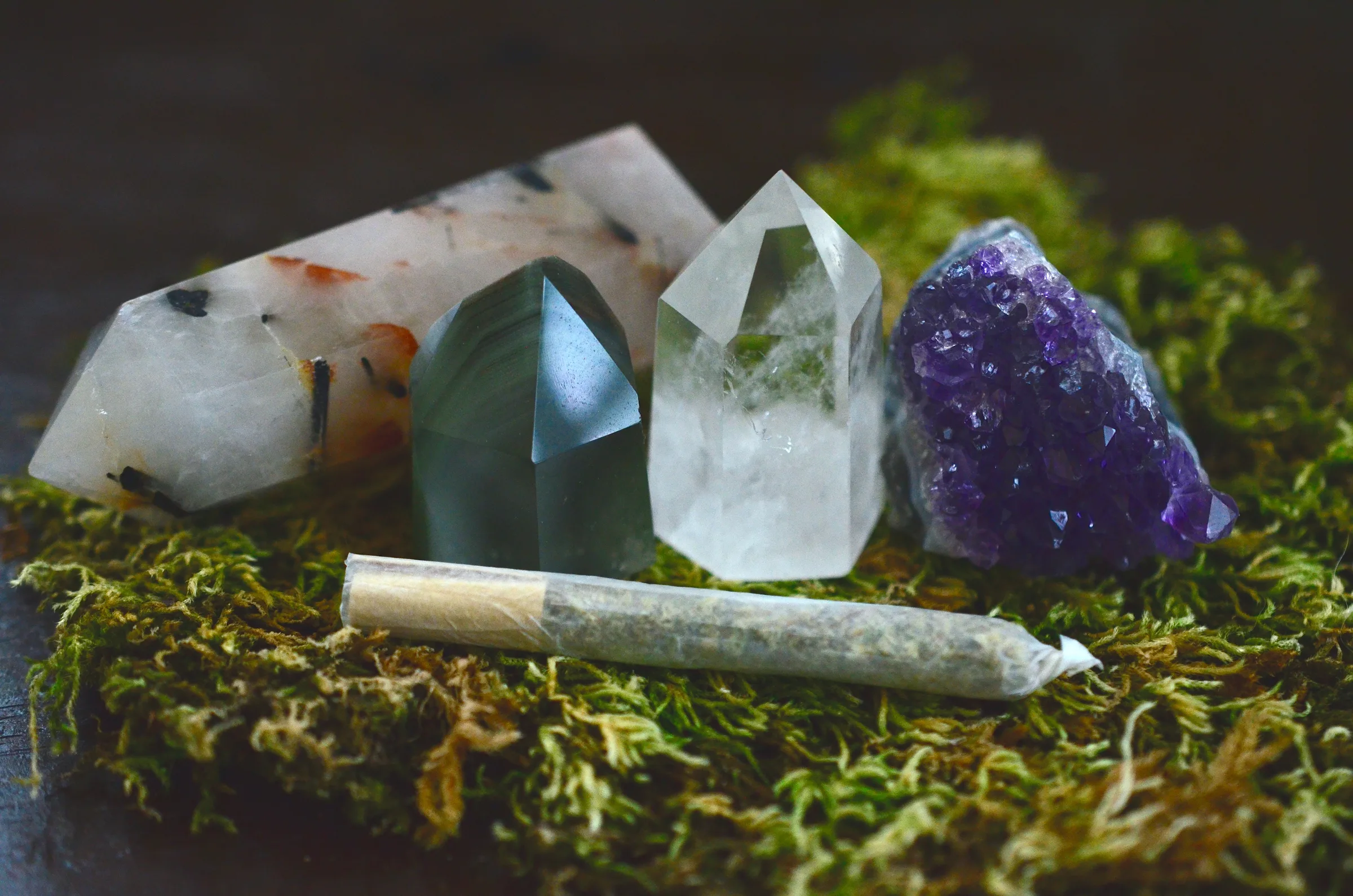 Crystals and rolled cannabis—prep and ritual mood.