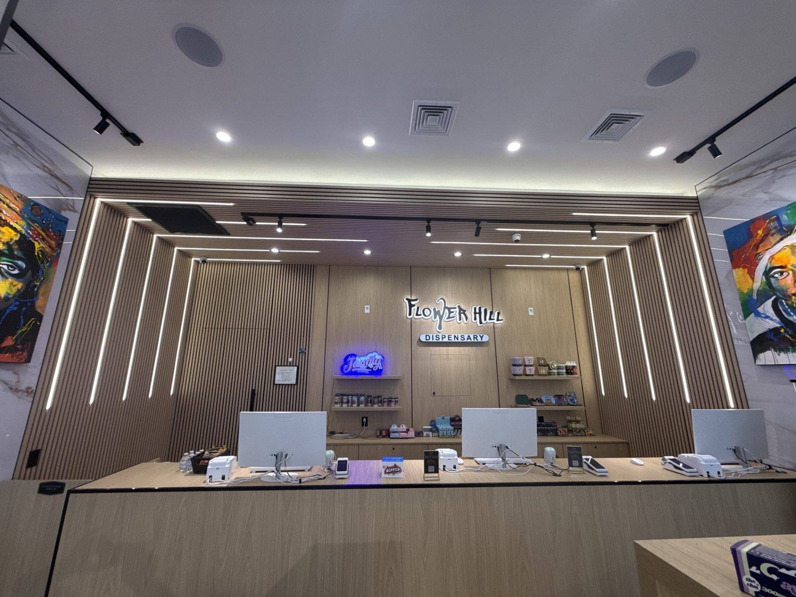 Flower Hill Dispensary back service counter with neon branding