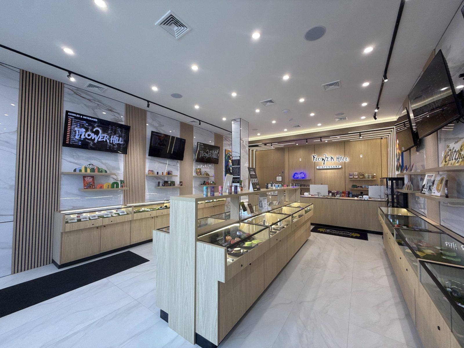 Flower Hill Dispensary sales floor with lit product display cases